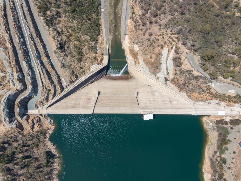 Bird's eye aerial view of Cotter Dam wall & Cotter reservoir, a supply source of potable water for the city of Canberra in the Australian Capital Territory, Australia. Low water levels due to drought